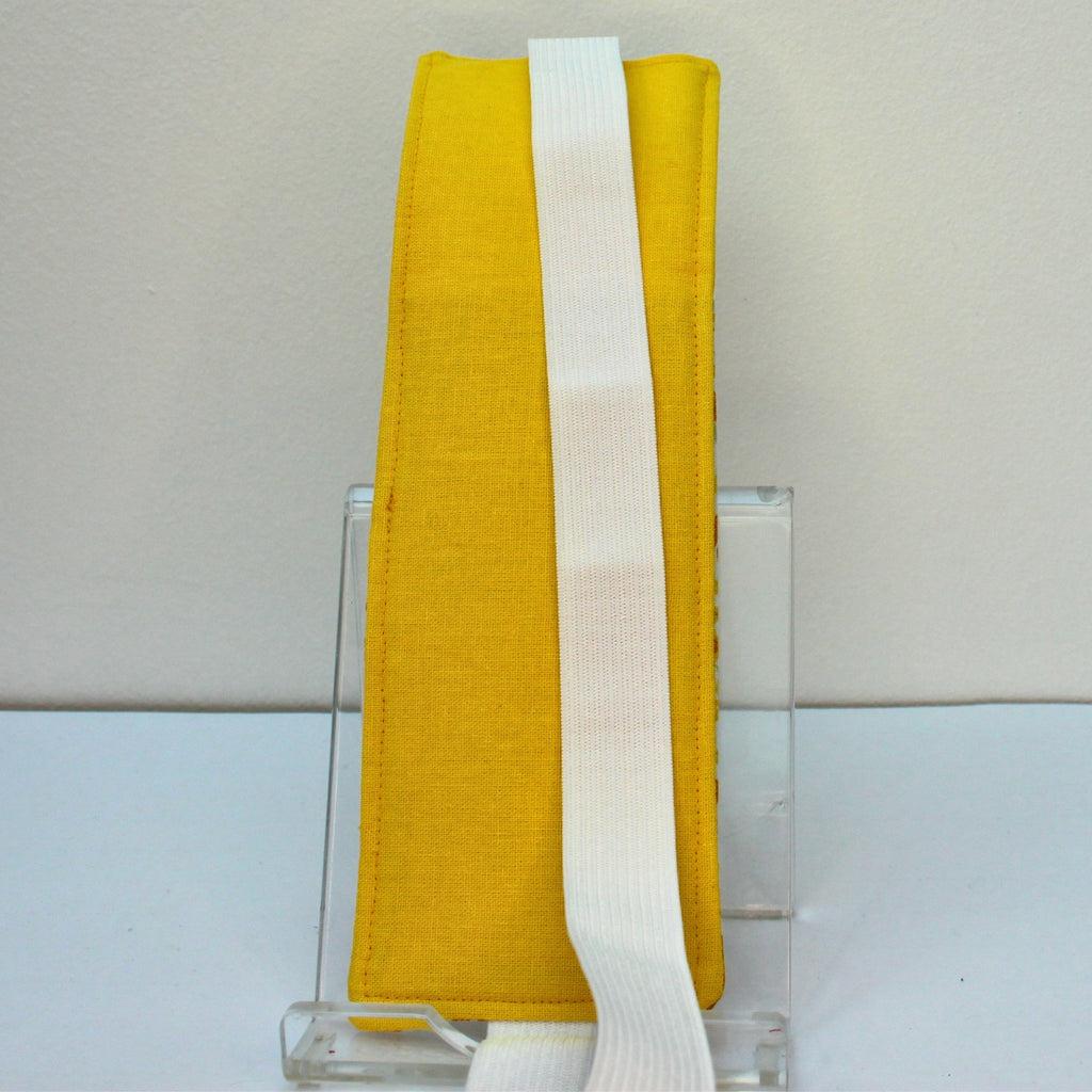 Reverse of handmade A4 fabric notebook pen pocket in Yellow and orange floral - white elastic— Dark Star Stitches