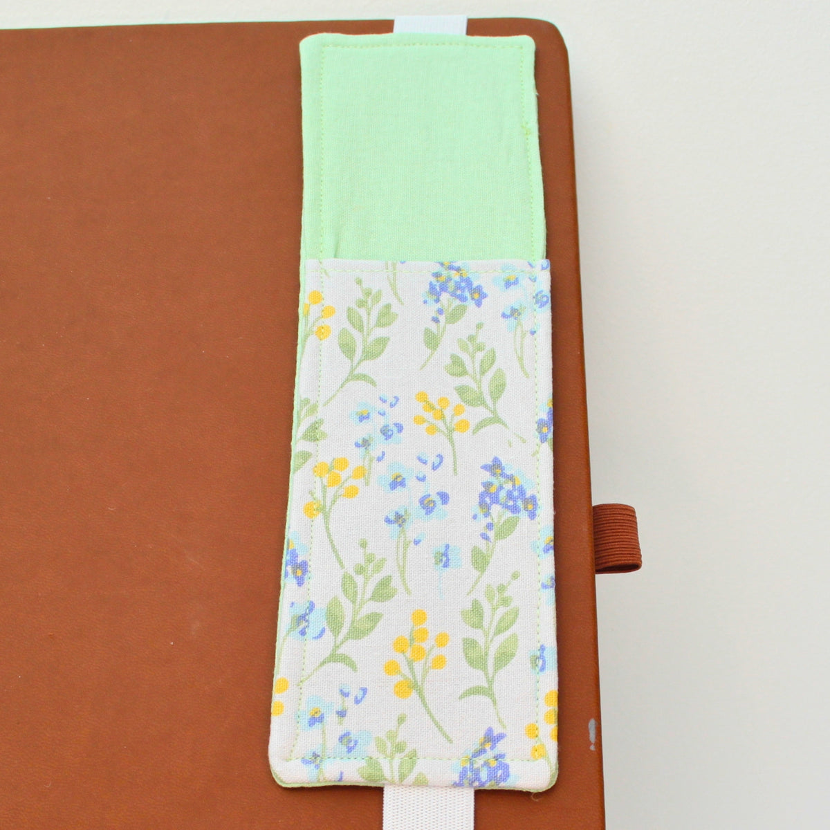 Handmade A4 fabric notebook pen pocket in Pale blue and yellow florals against white - white elastic — Dark Star Stitches 