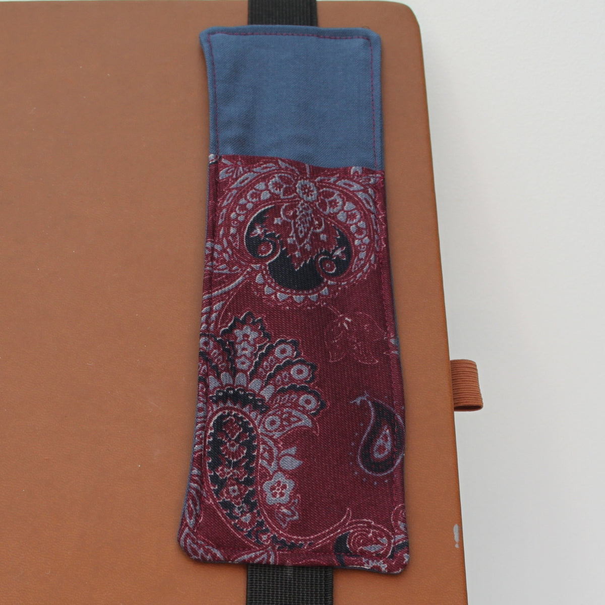 Handmade A4 fabric notebook pen pocket in Burgundy and grey paisley against dark grey - black elastic — Dark Star Stitches 