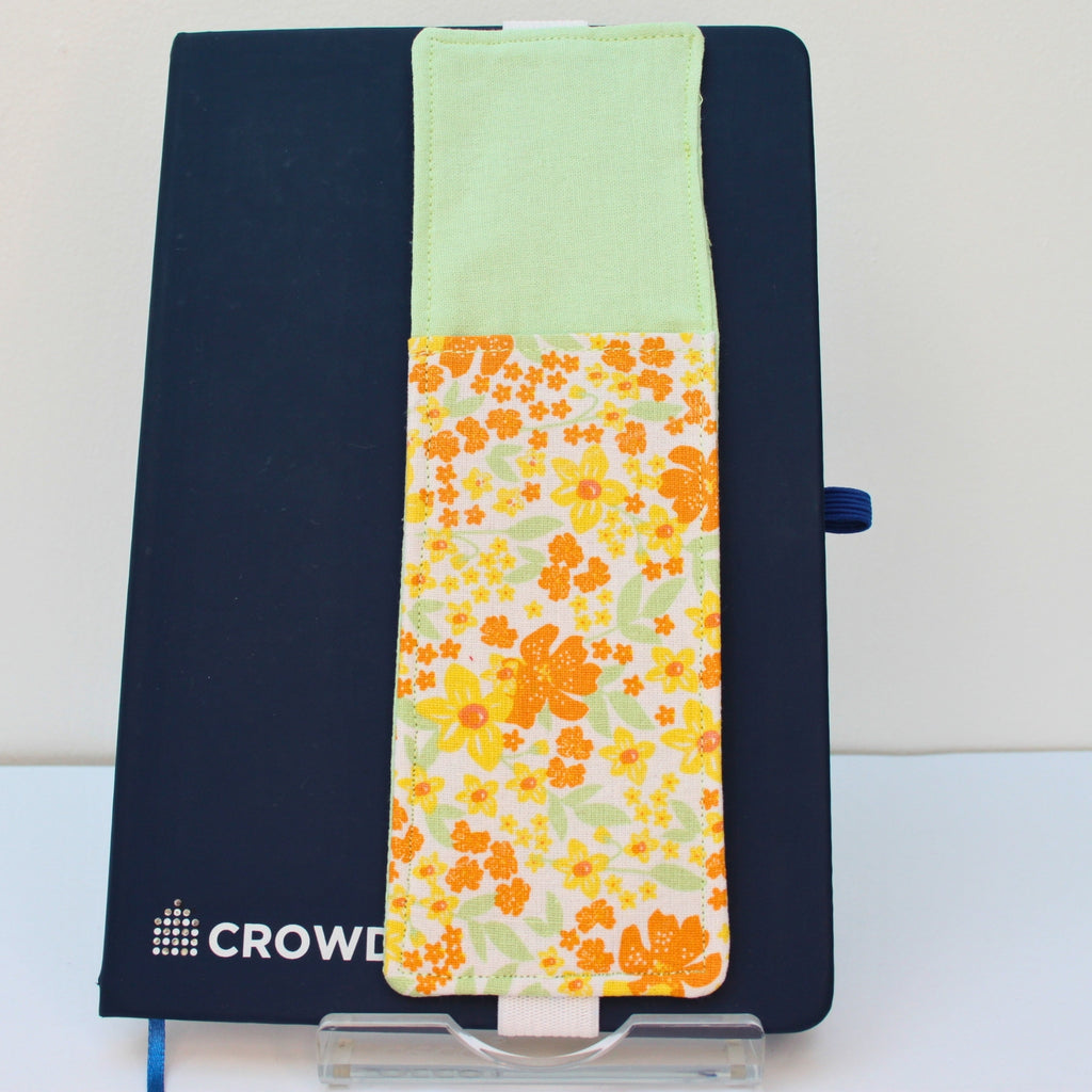 Handmade A5 fabric notebook pen pocket in yellow and orange floral fabric, white elastic — Dark Star Stitches