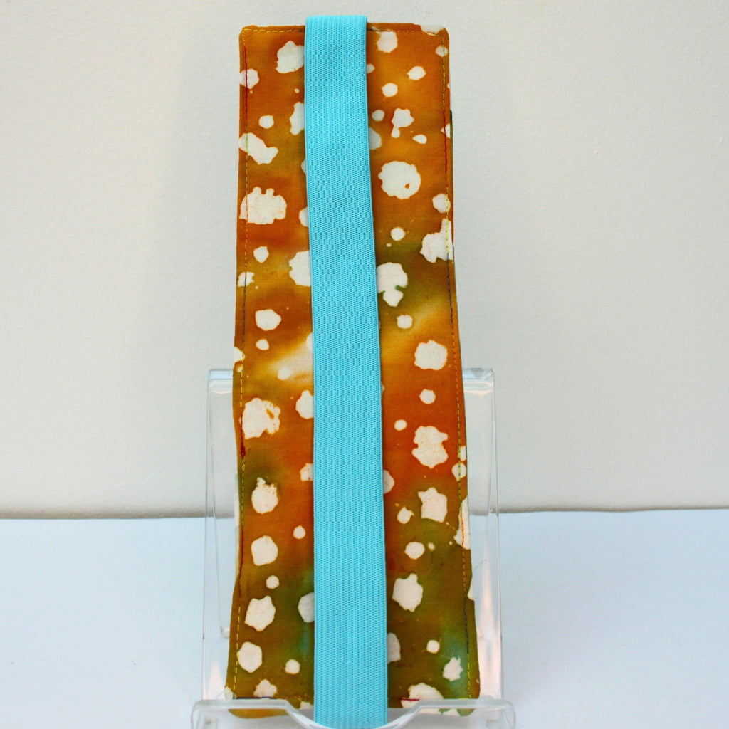 Reverse of handmade A5 fabric notebook pen pocket in tie dye with patterns fabric, light blue elastic — Dark Star Stitches