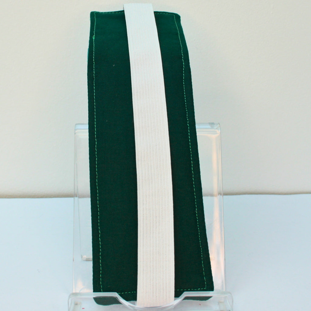 Reverse of handmade A5 fabric notebook pen pocket in green/grey arrow and line pattern, white elastic — Dark Star Stitches