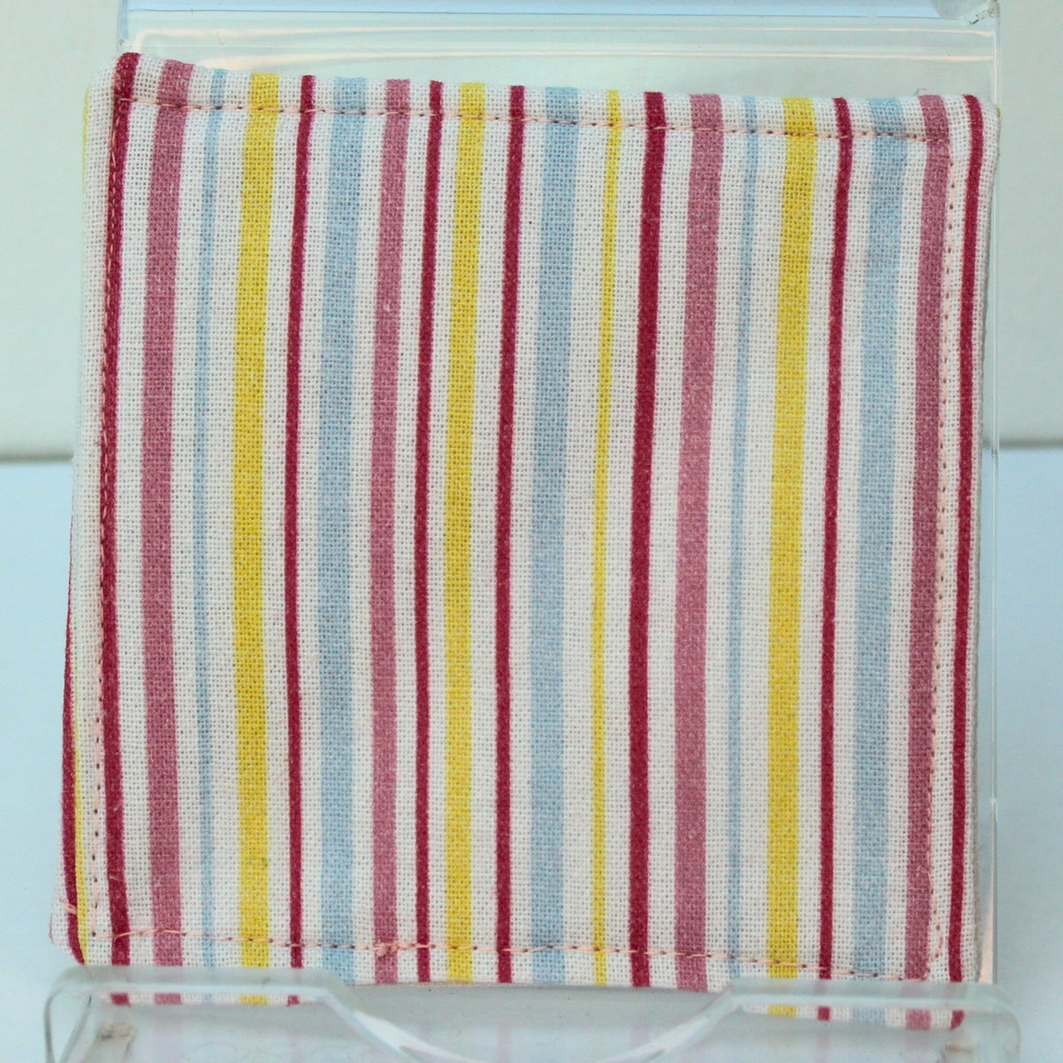 Reverse of handmade fabric bookmark in candy stripe corner and back with pale pink floral inner — Dark Star Stitches