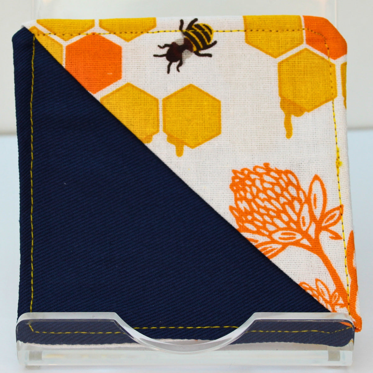 Handmade fabric bookmark in bee yellow and orange honeycomb with orange plant corner and back, dark blue inner — Dark Star Stitches
