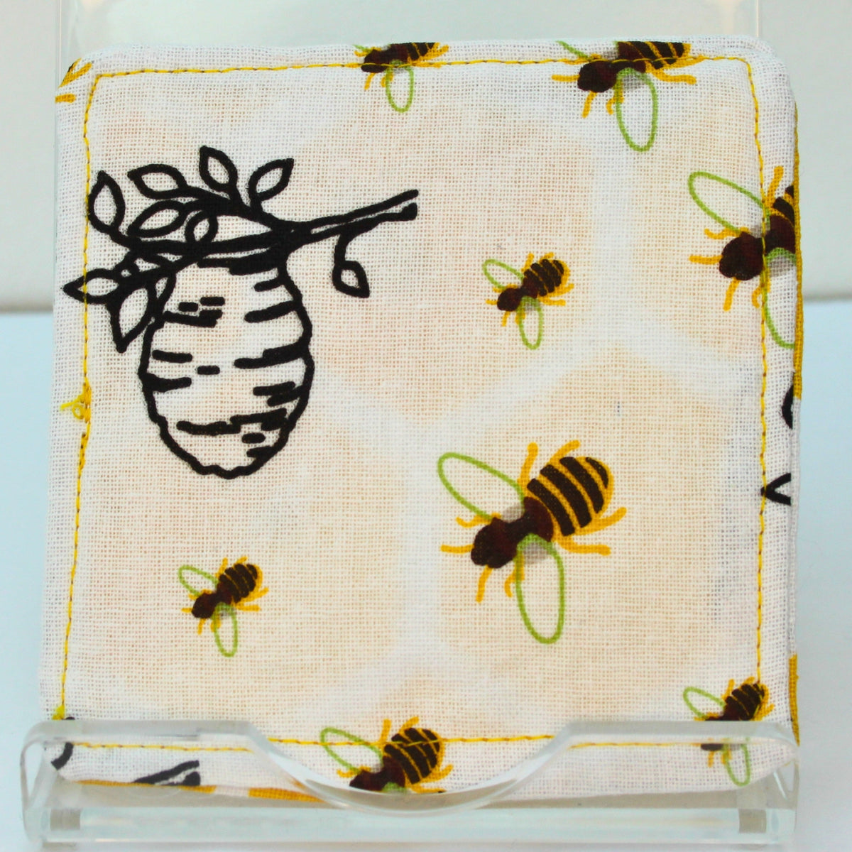 Reverse of handmade fabric bookmark in bee and beehive on white corner and back with yellow honeycomb inner — Dark Star Stitches
