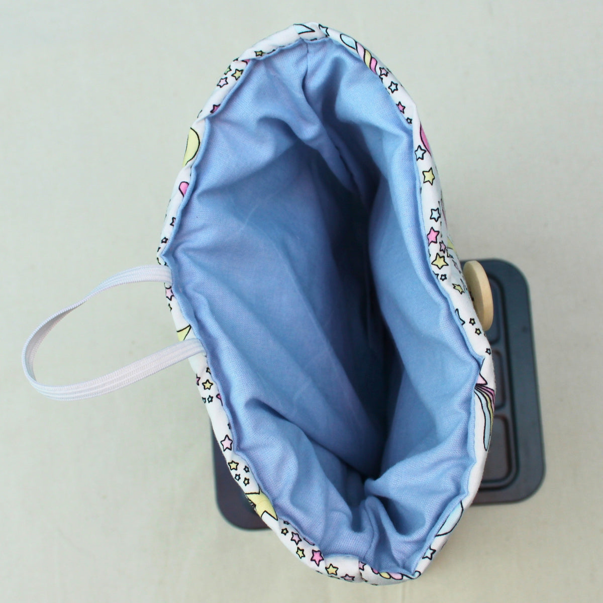 Lining inside handmade quilted booksleeve in pastel moons and stars fabric — Dark Star Stitches small batch accessory