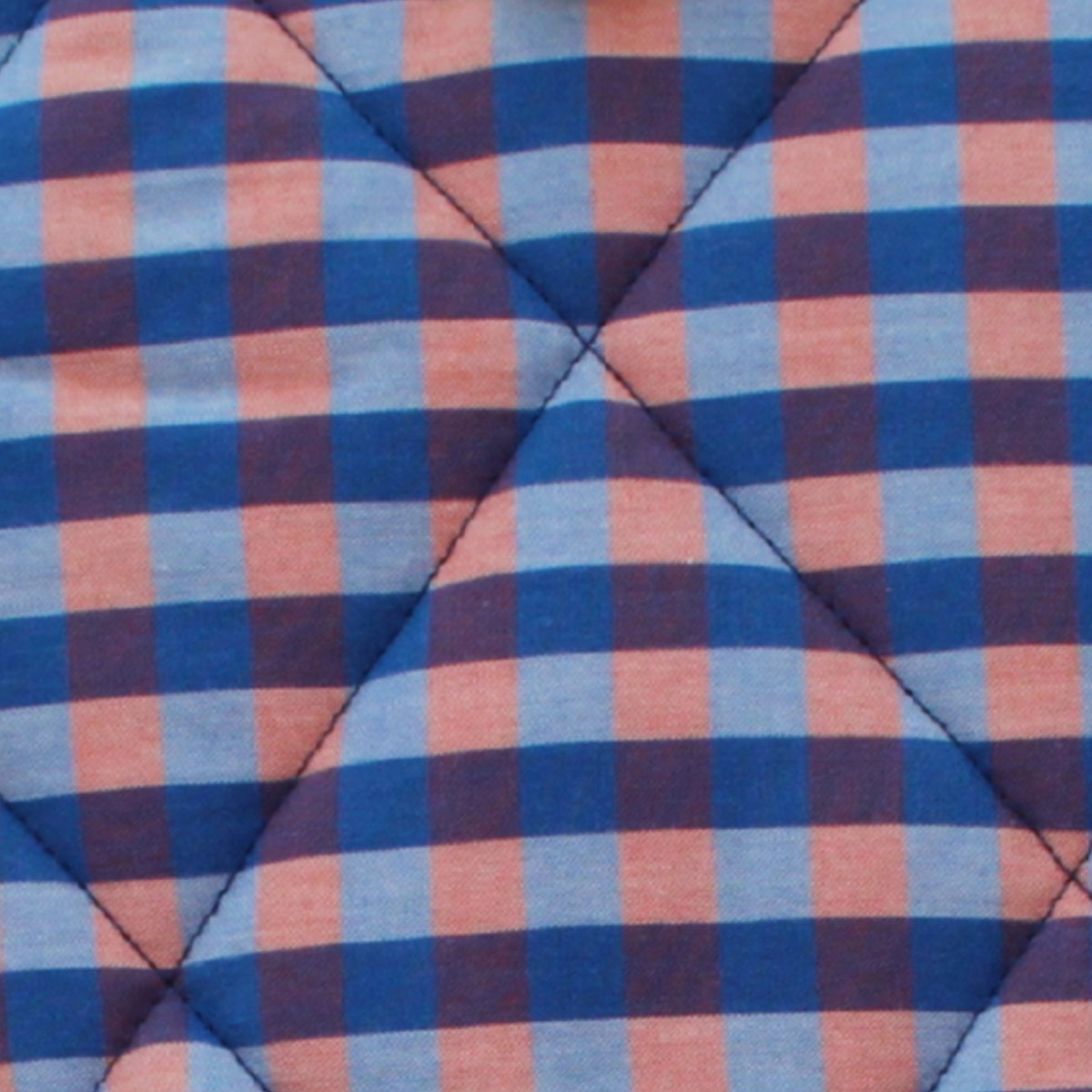 Close-up of orange and blue check pattern on cotton fabric used in handmade quilted booksleeve set — Dark Star Stitches