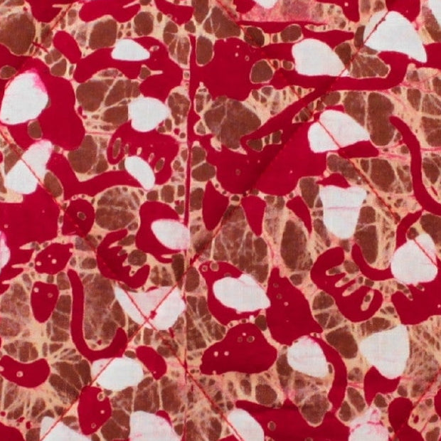 Close-up of red, brown and white pattern on cotton fabric used in handmade quilted booksleeve set — Dark Star Stitches
