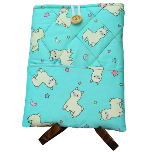 Quilted handmade booksleeve in cartoon alpaca bright blue fabric with front pocket — Dark Star Stitches