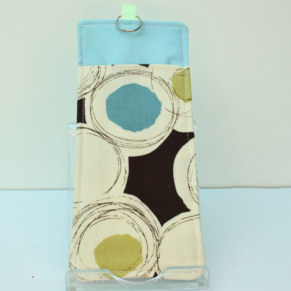 Handmade double sided lanyard pocket in black circles and splodges on brown fabric, pale green ribbon — Dark Star Stitches