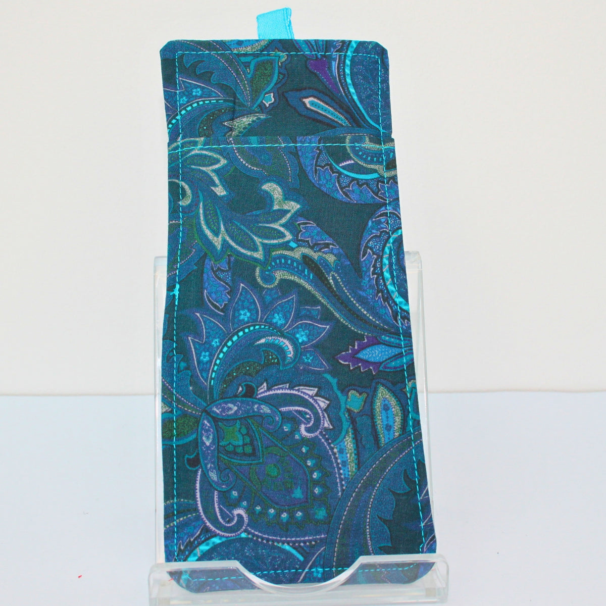 Reverse of handmade double sided lanyard pocket in electric blue and pink paisley on green fabric, electric blue ribbon — Dark Star Stitches
