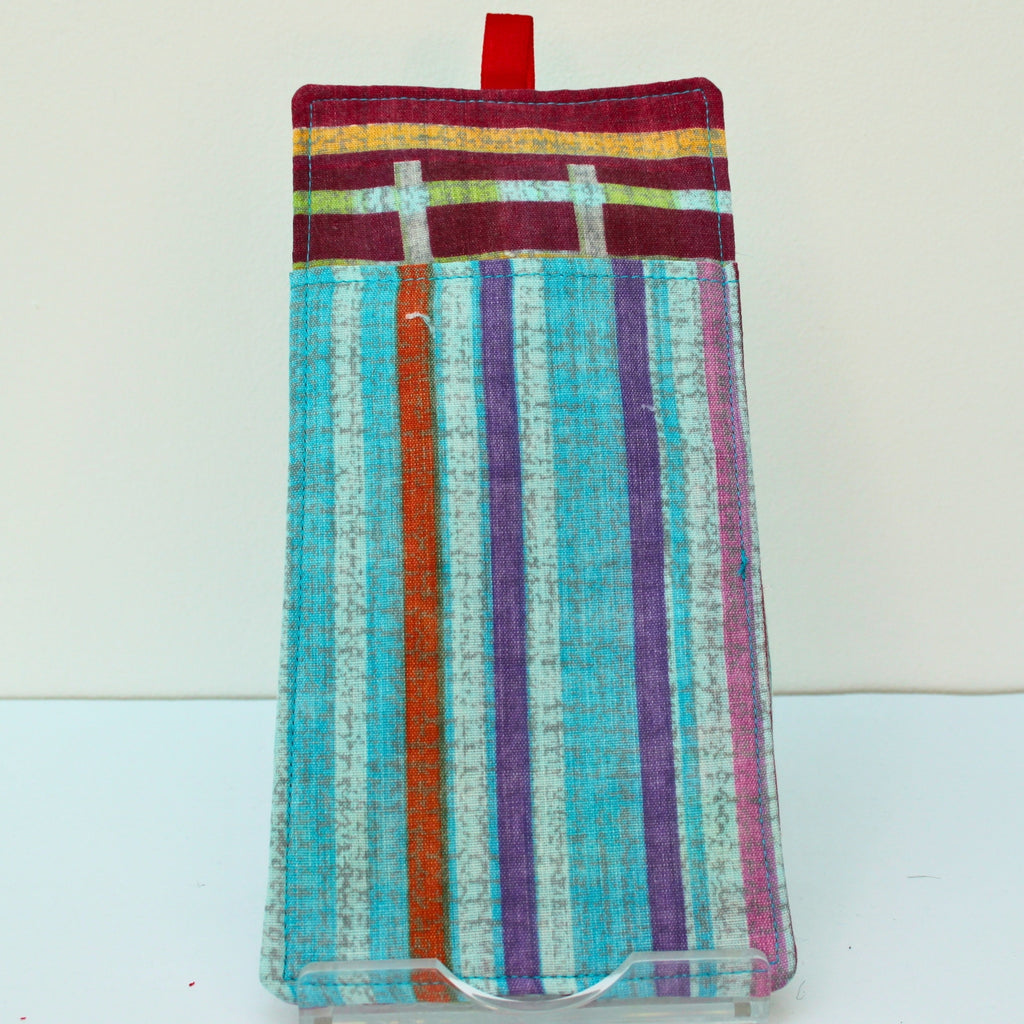 Reverse of handmade double sided lanyard pocket in multi-coloured stripes fabric, red ribbon — Dark Star Stitches