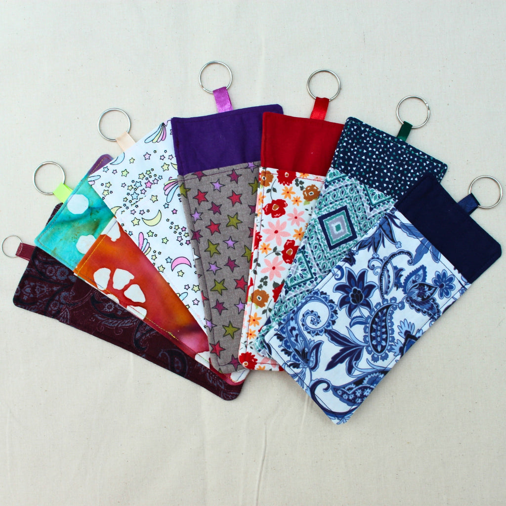 Handmade double sided fabric lanyard pocket showing range of fabric designs — Dark Star Stitches small batch accessory