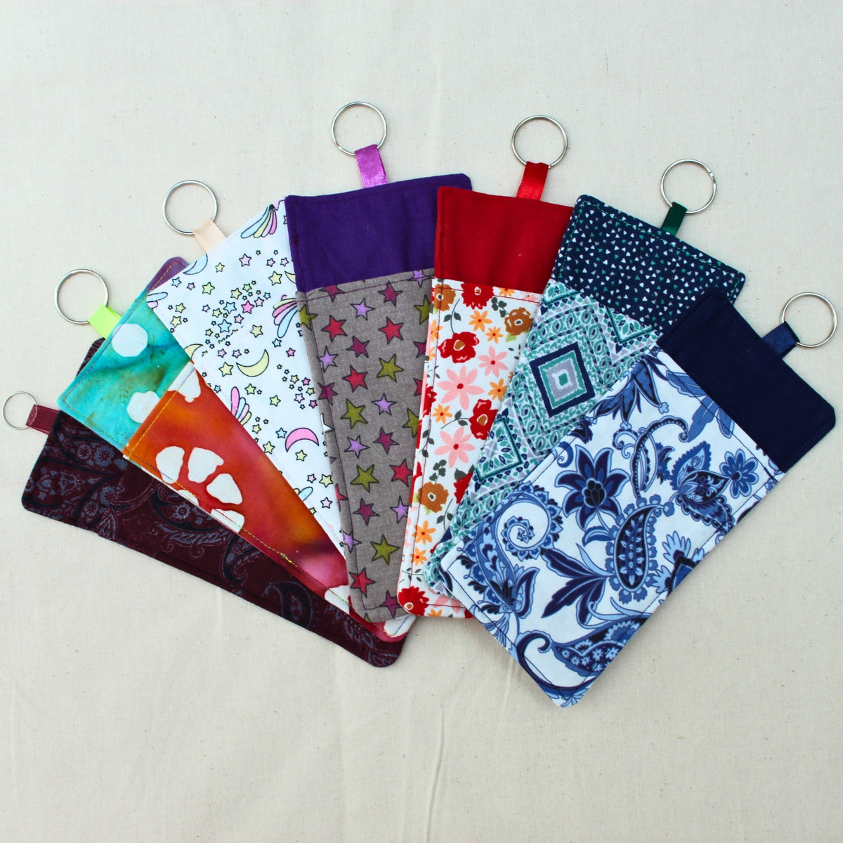 Handmade double sided fabric lanyard pocket showing range of fabric designs — Dark Star Stitches small batch accessory