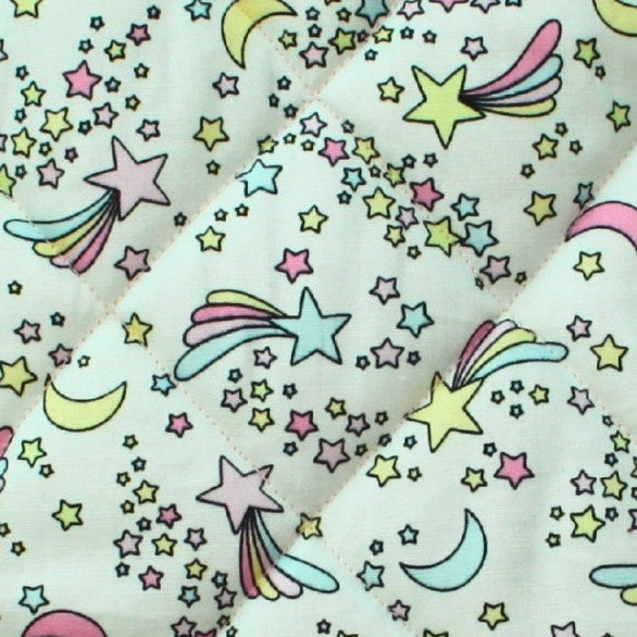 Close-up of pastel moons and stars pattern on cotton fabric used in handmade quilted booksleeve set — Dark Star Stitches