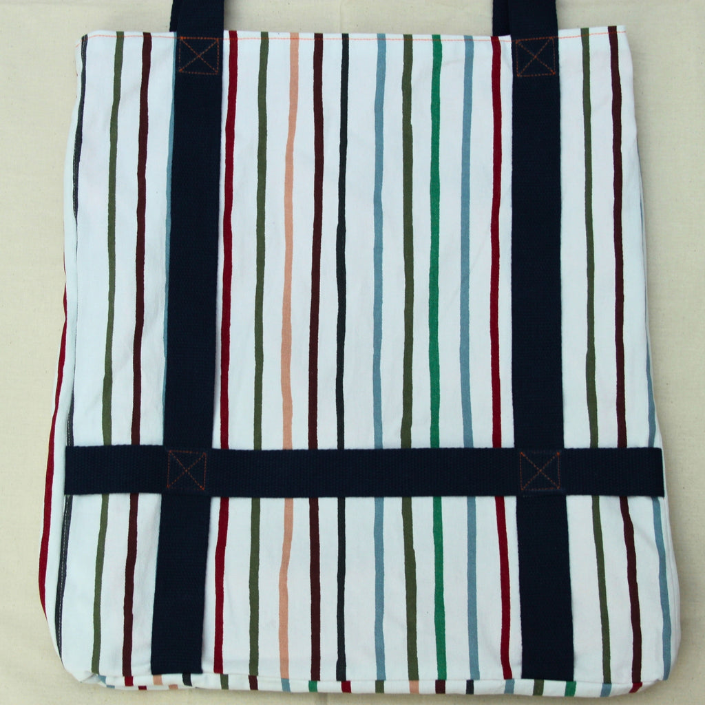 Hat holder strap detail on handmade fabric tote bag in multi-colour stripes with blue lining and navy strap — Dark Star Stitches
