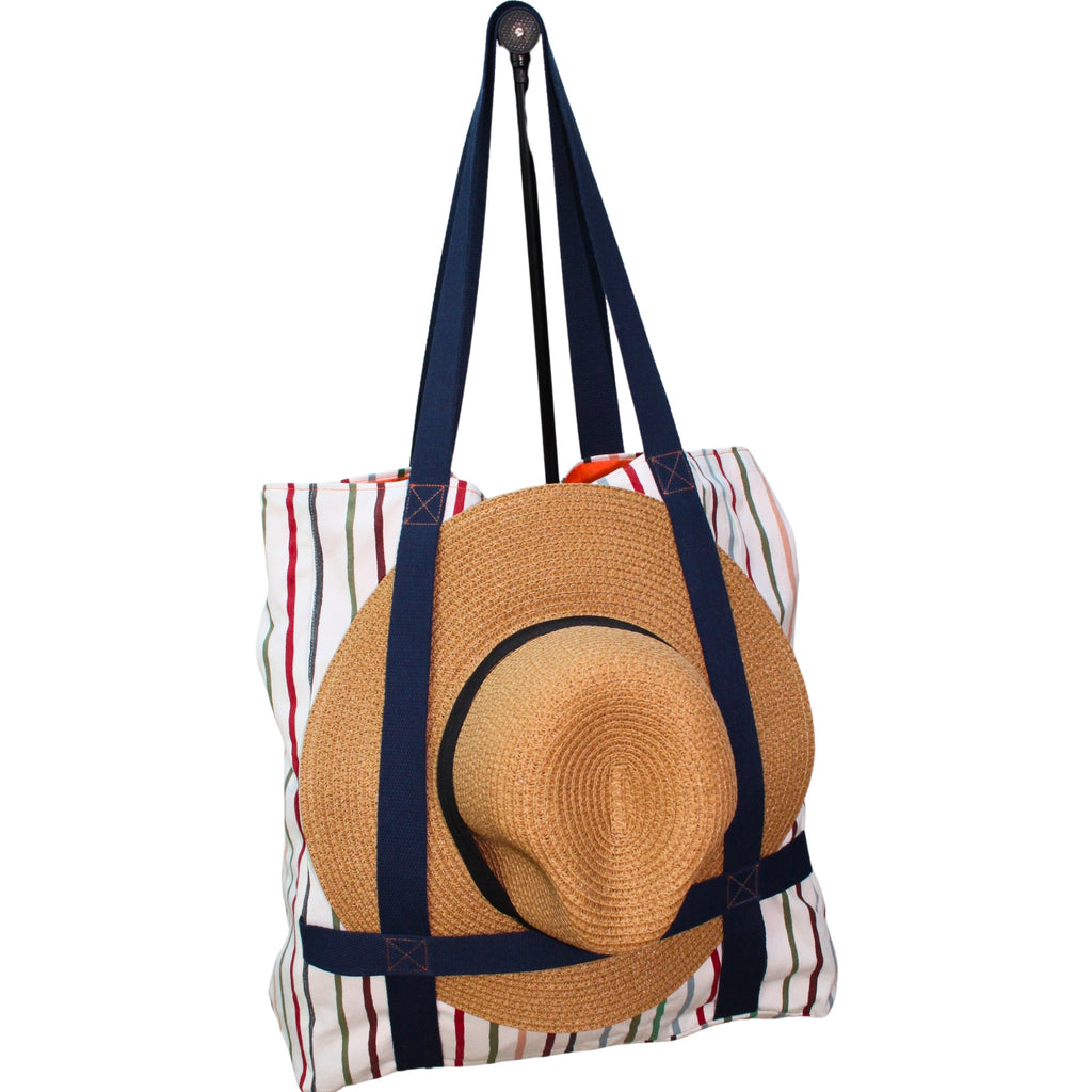 Front view in use of handmade fabric tote bag with hat holder in multi-colour stripes with orange lining and navy strap — Dark Star Stitches